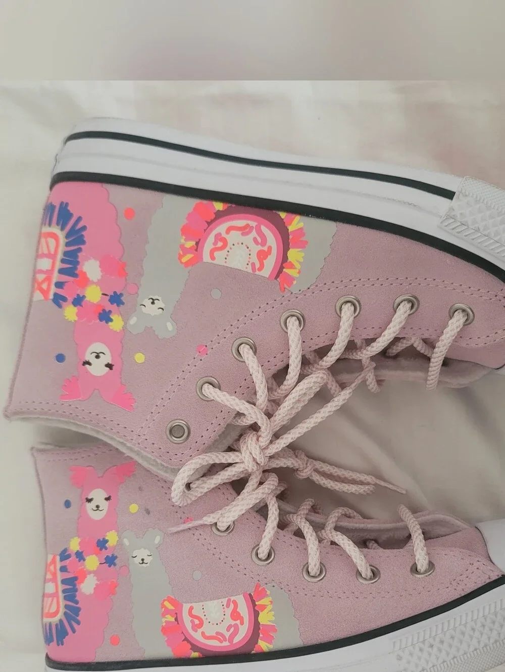 Pink Converse Chuck Taylor All Star High sneakers feature a playful llama